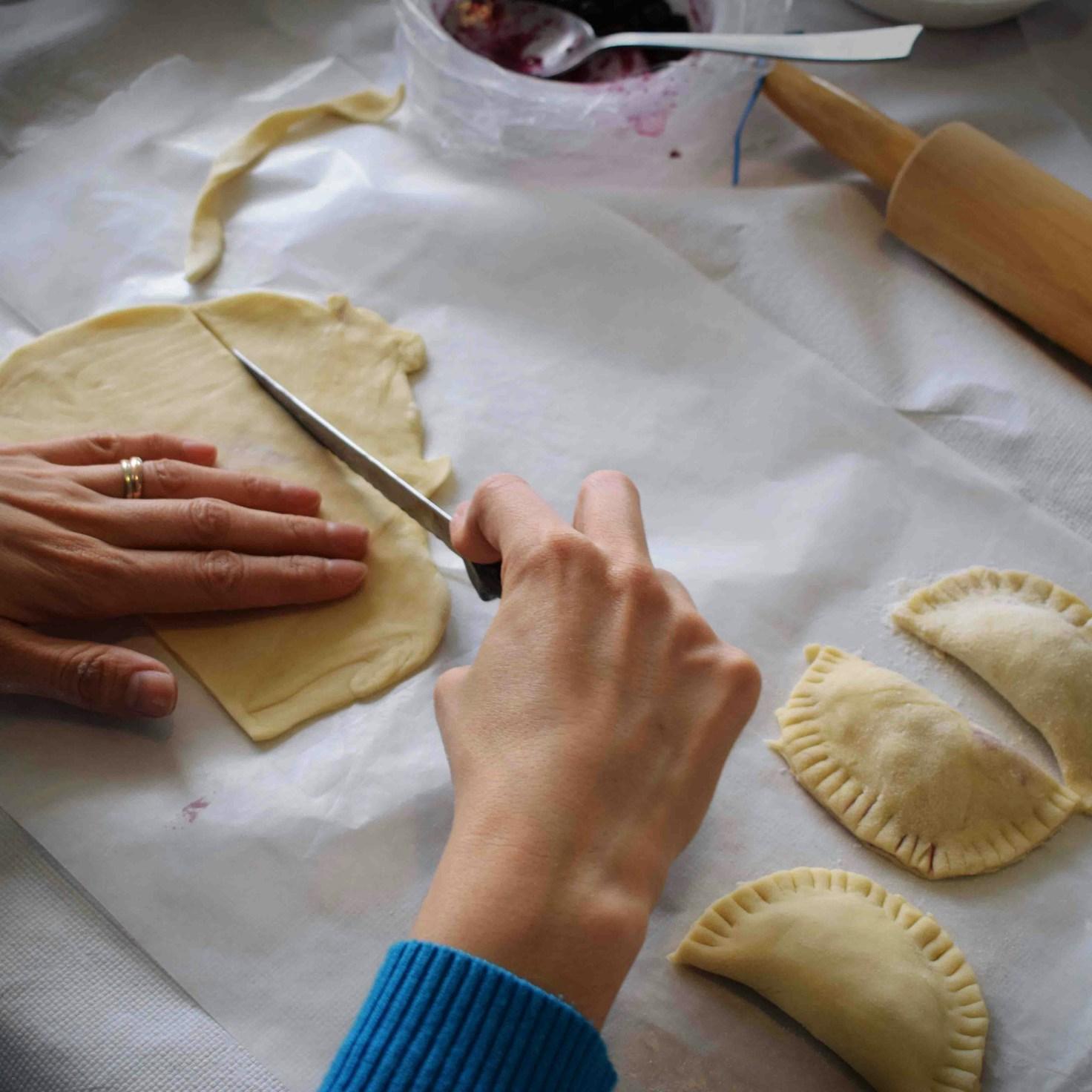 Community members collaborating in a modern kitchen space, sharing recipes and cooking techniques